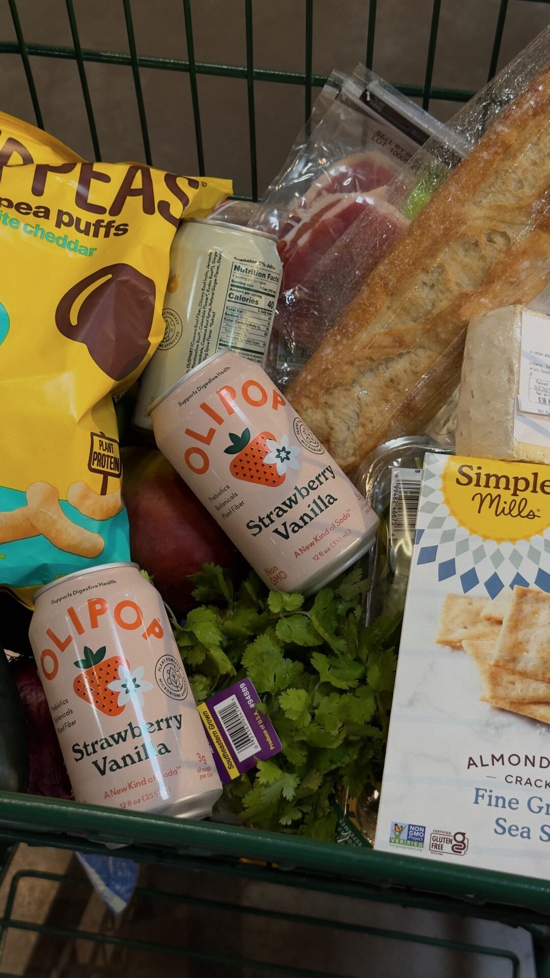 Einkaufswagen mit Olipop-Dosen, Snacks und Brot für Ihren finanziell freien Lebensstil.